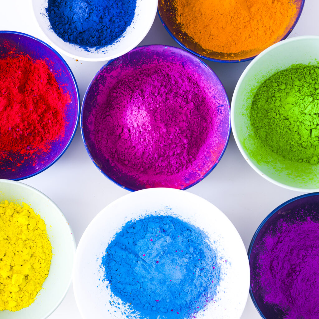 Vibrant turquoise and blue dye powders showing high concentration and purity for textile and paper applications.